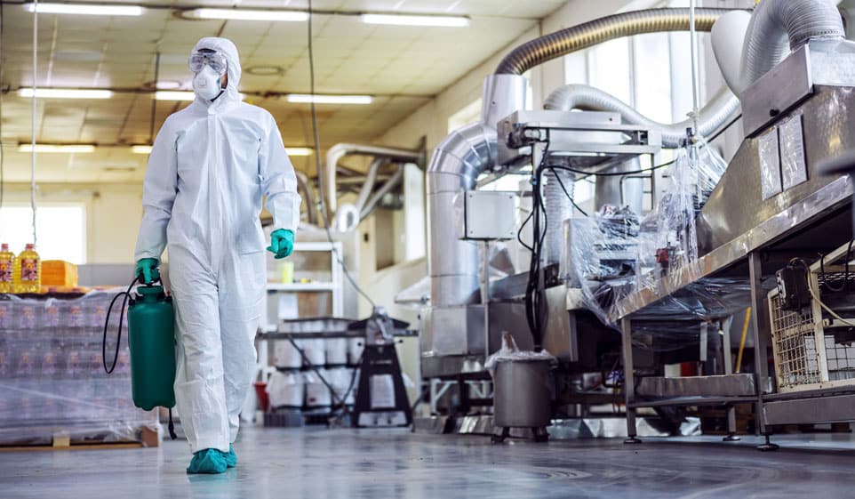 disinfection worker in industrial setting